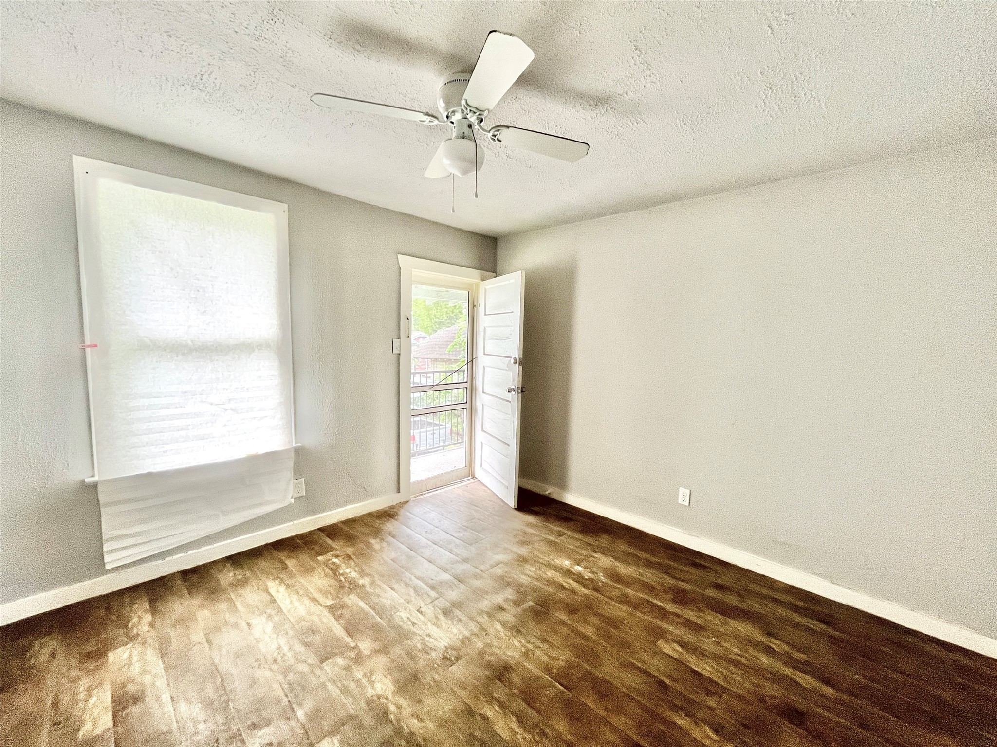 6823 Ave East Houston, TX 77011 - Photo 2 of 16 wooden floor in an empty room with a window