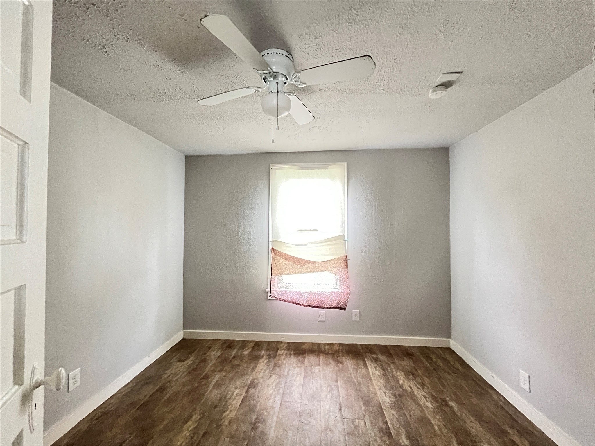 6823 Ave East Houston, TX 77011 - Photo 9 of 16 a view of an empty room with wooden floor and a window