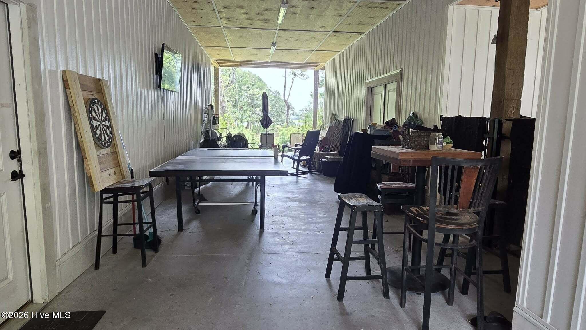 2659 Seashore Road Southwest Supply, NC 28462 - Photo 66 of 75 waterview ground floor center Breezeway Garage or Game ROOM with side Horse Stall , and 2 Heated and Cooled ROOMS Currently used as a SHOP AND STORAGE AREA AND A GYM