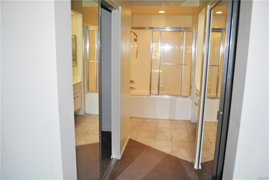 124 Cartier Aisle Irvine, CA 92620 - Photo 26 of 31 a bathroom with a glass shower door