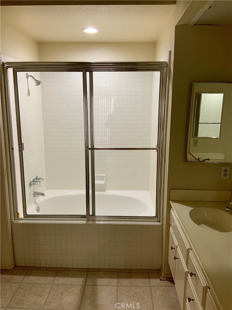 124 Cartier Aisle Irvine, CA 92620 - Photo 28 of 31 a bathroom with a bathtub and a shower