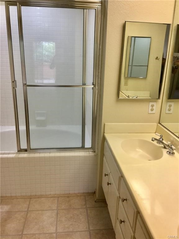 124 Cartier Aisle Irvine, CA 92620 - Photo 29 of 31 a bathroom with a granite countertop sink a mirror and a bathtub