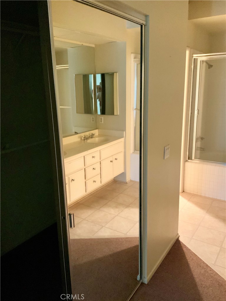 124 Cartier Aisle Irvine, CA 92620 - Photo 31 of 31 a view of bathroom with a glass door shower and sink
