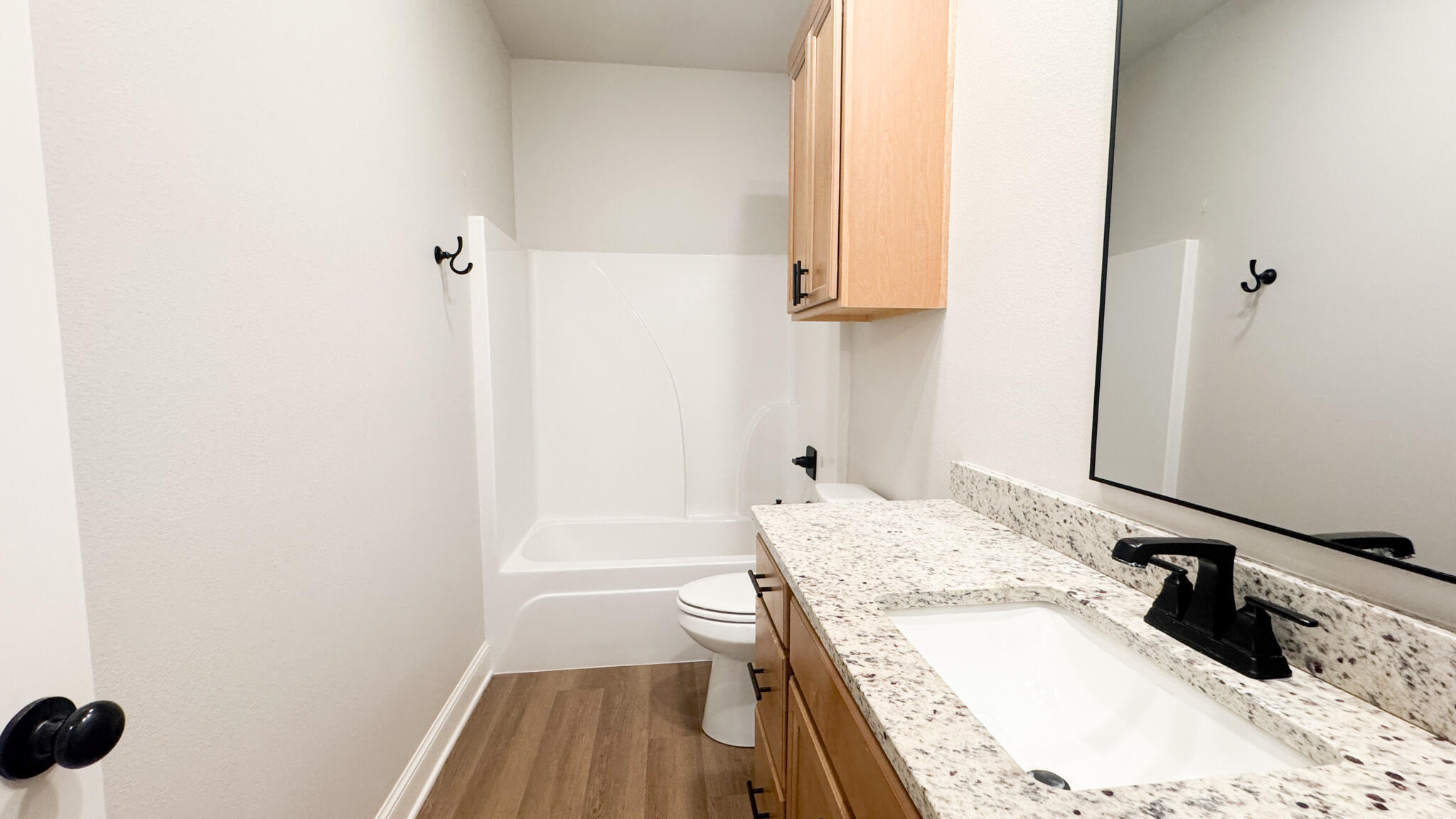 2544 137th Street Lubbock, TX 79423 - Photo 11 of 43 a bathroom with a granite countertop sink a toilet and vanity