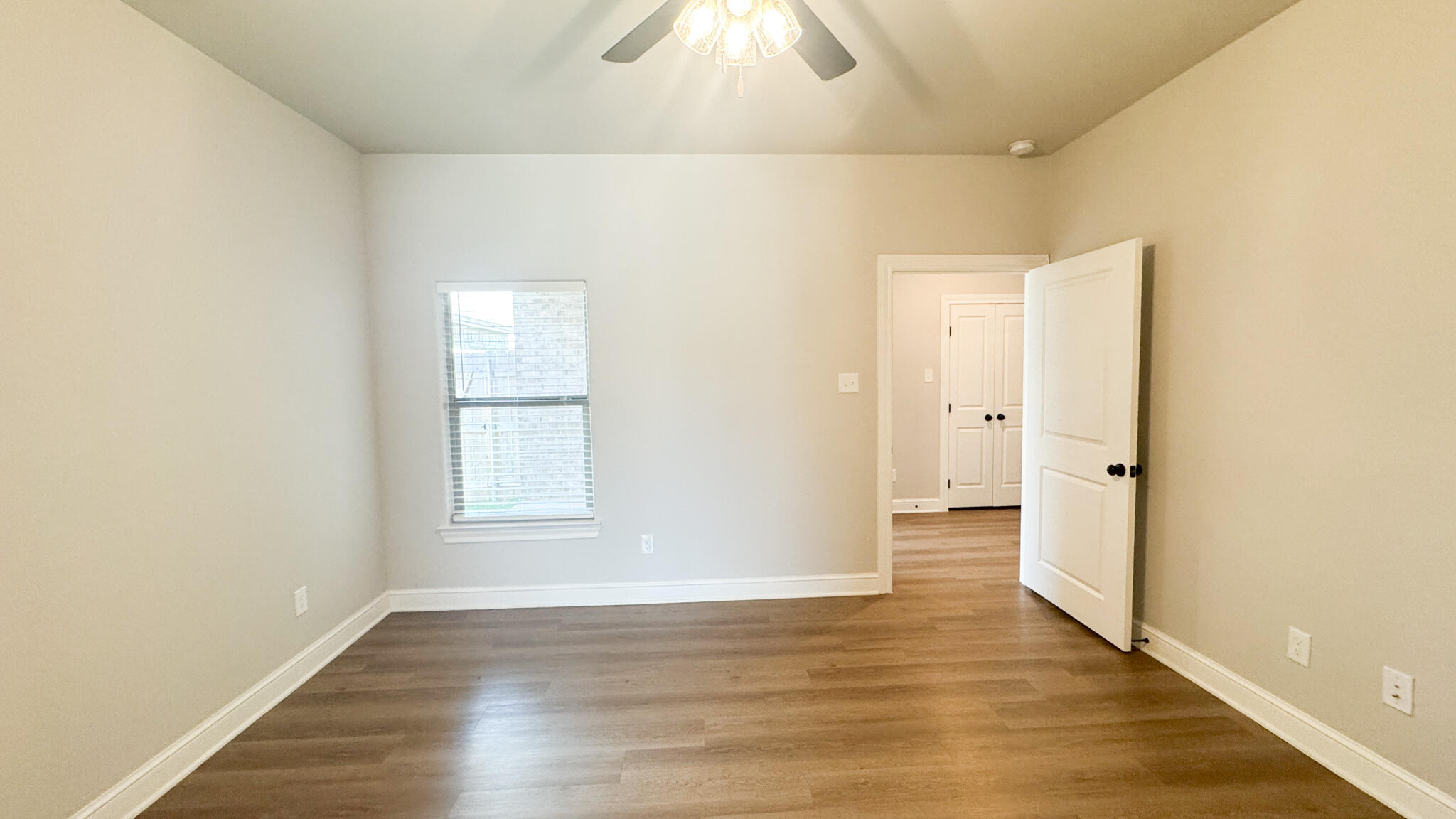 2544 137th Street Lubbock, TX 79423 - Photo 13 of 43 an empty room with wooden floor and windows