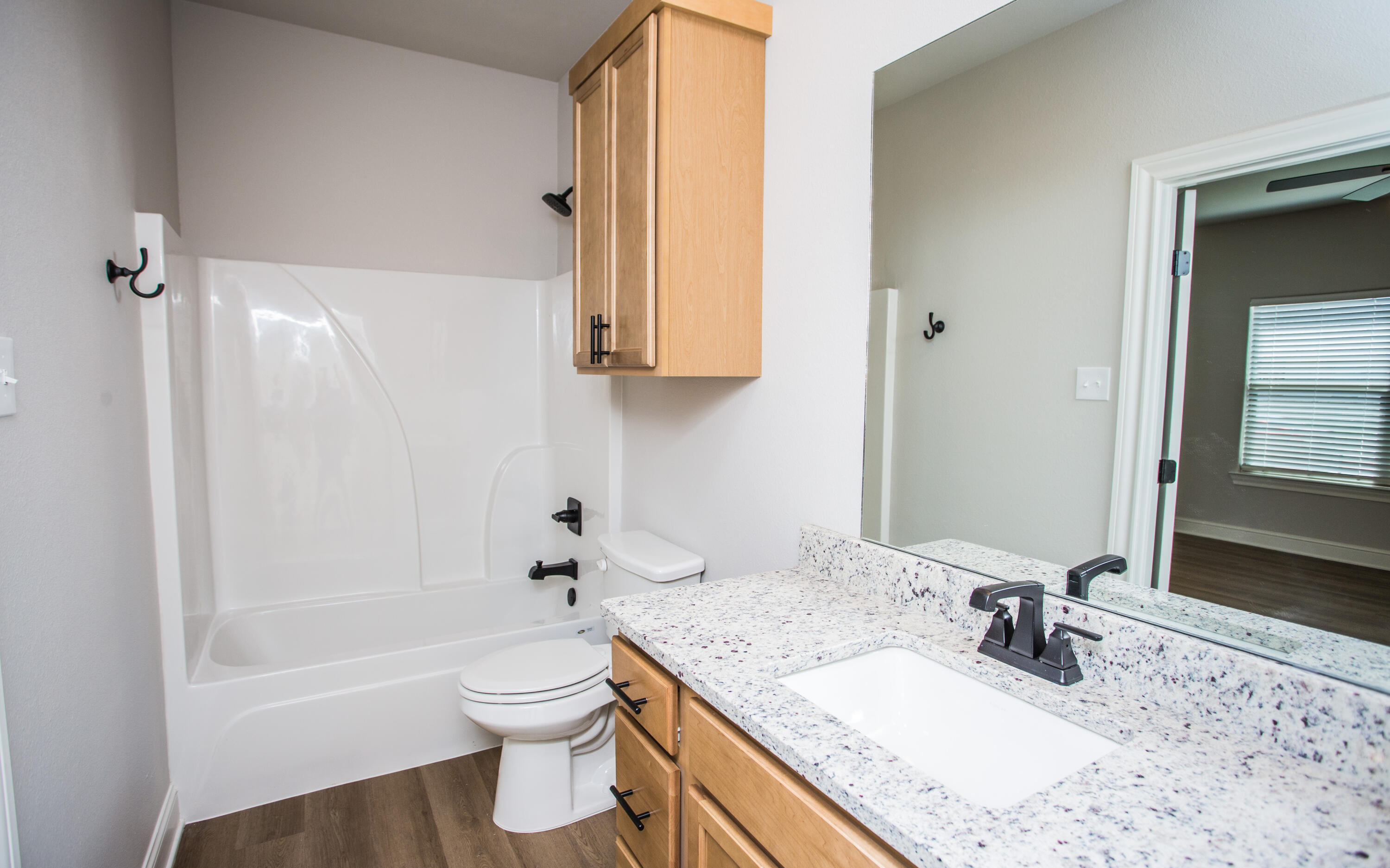 2544 137th Street Lubbock, TX 79423 - Photo 17 of 43 a bathroom with a granite countertop sink toilet and shower