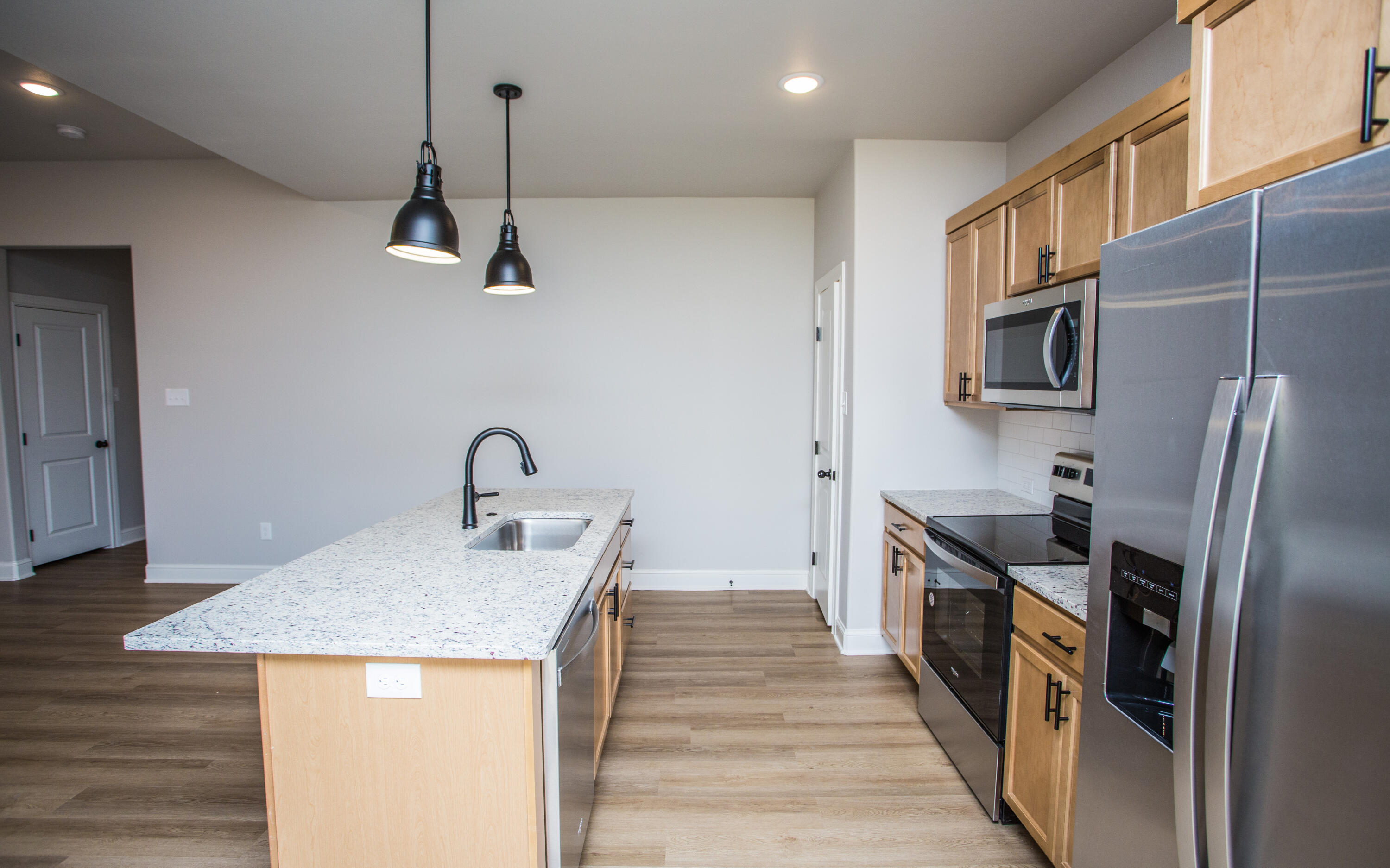 2544 137th Street Lubbock, TX 79423 - Photo 23 of 43 a kitchen with stainless steel appliances granite countertop a sink and a refrigerator