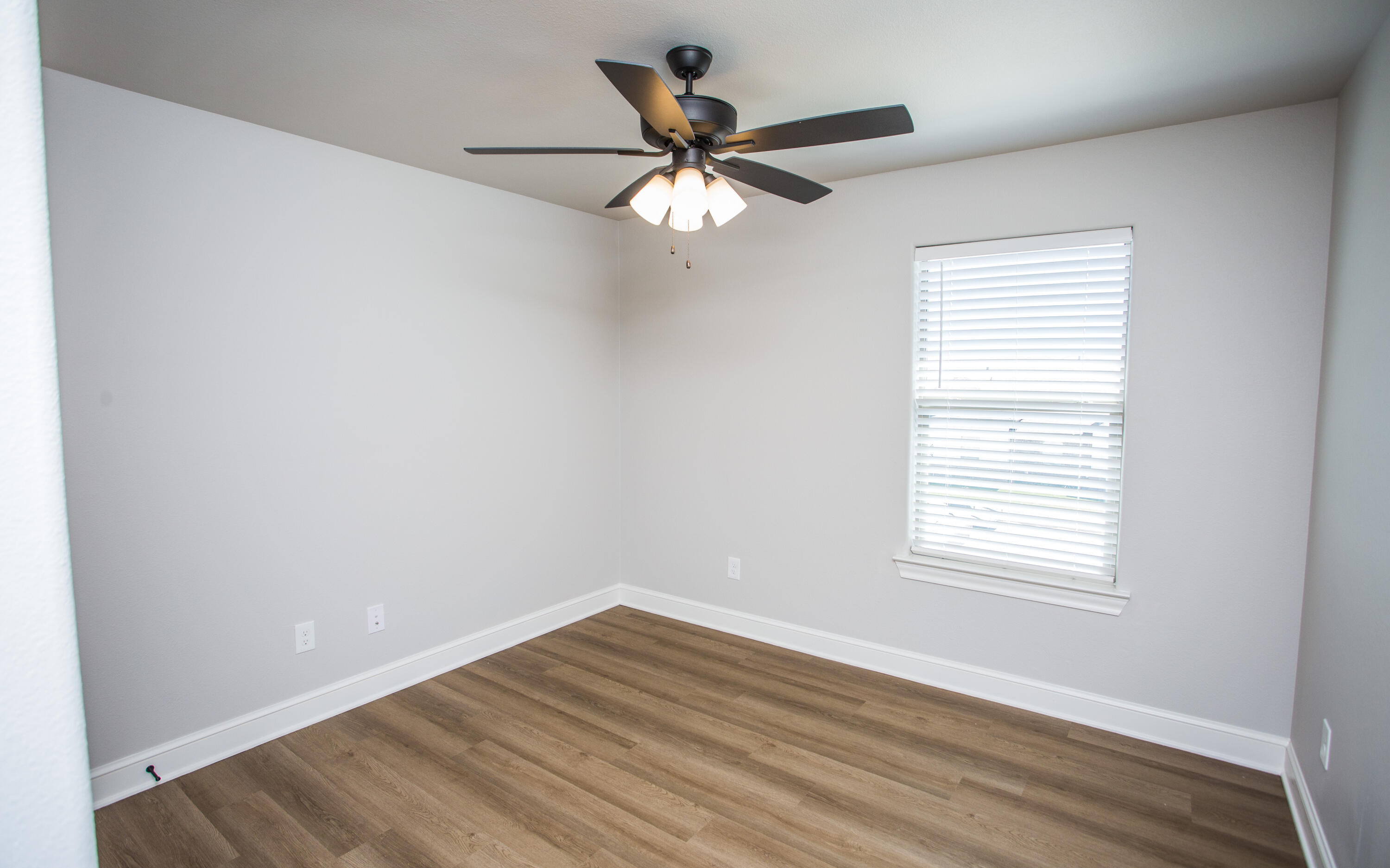 2544 137th Street Lubbock, TX 79423 - Photo 32 of 43 a view of an empty room with wooden floor and a window