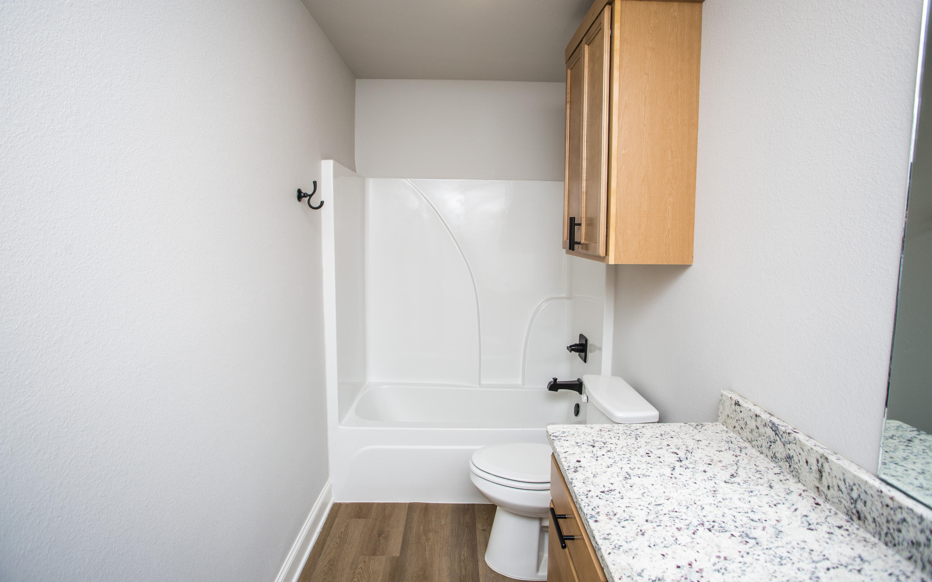 2544 137th Street Lubbock, TX 79423 - Photo 36 of 43 a bathroom with a toilet a sink and bathtub