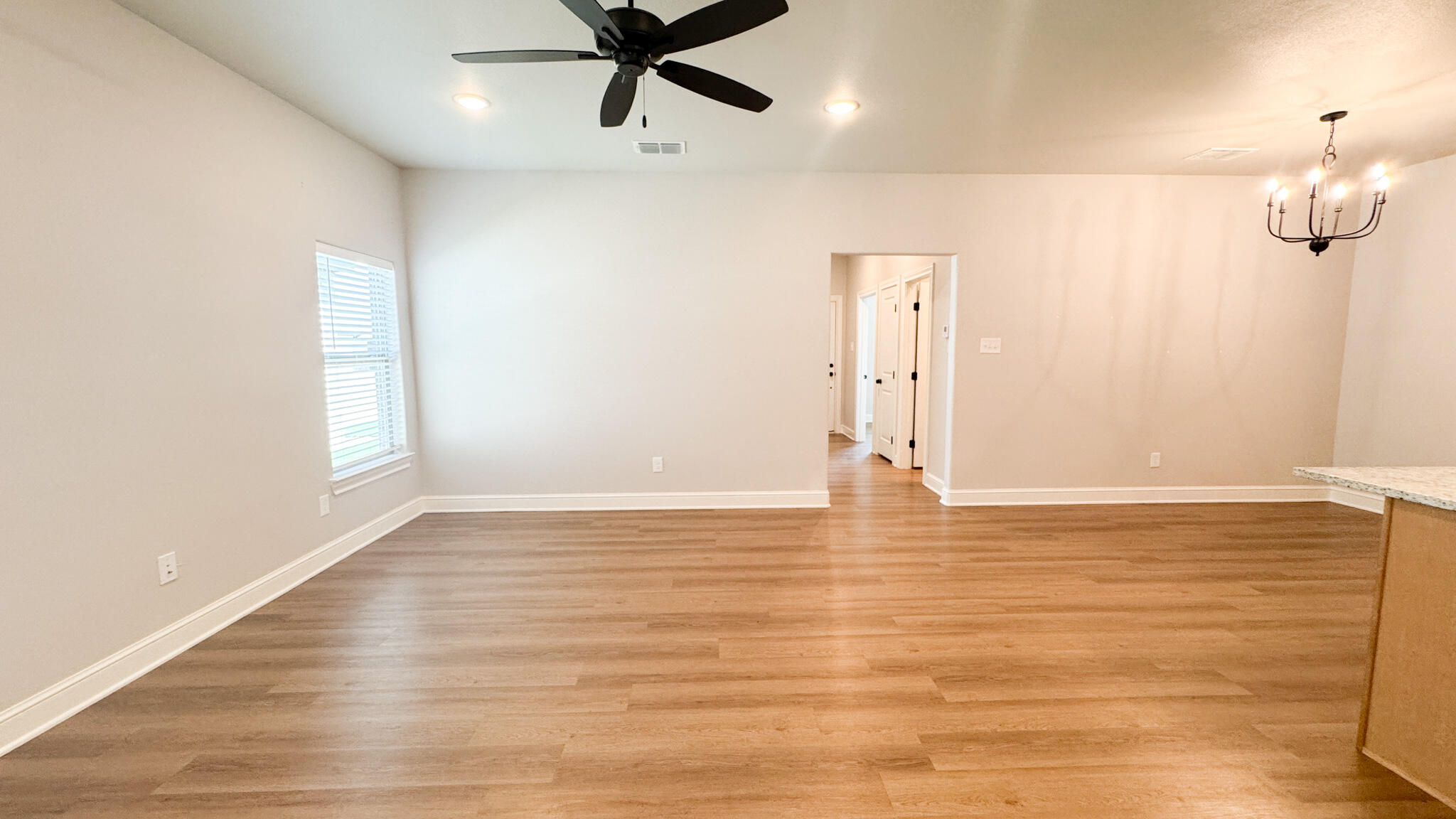 2544 137th Street Lubbock, TX 79423 - Photo 10 of 43 a view of empty room with wooden floor and fan