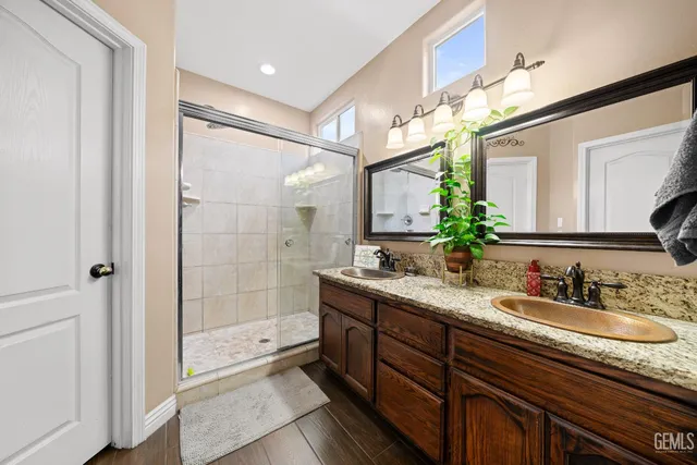 a bathroom with a sink double vanity and a mirror