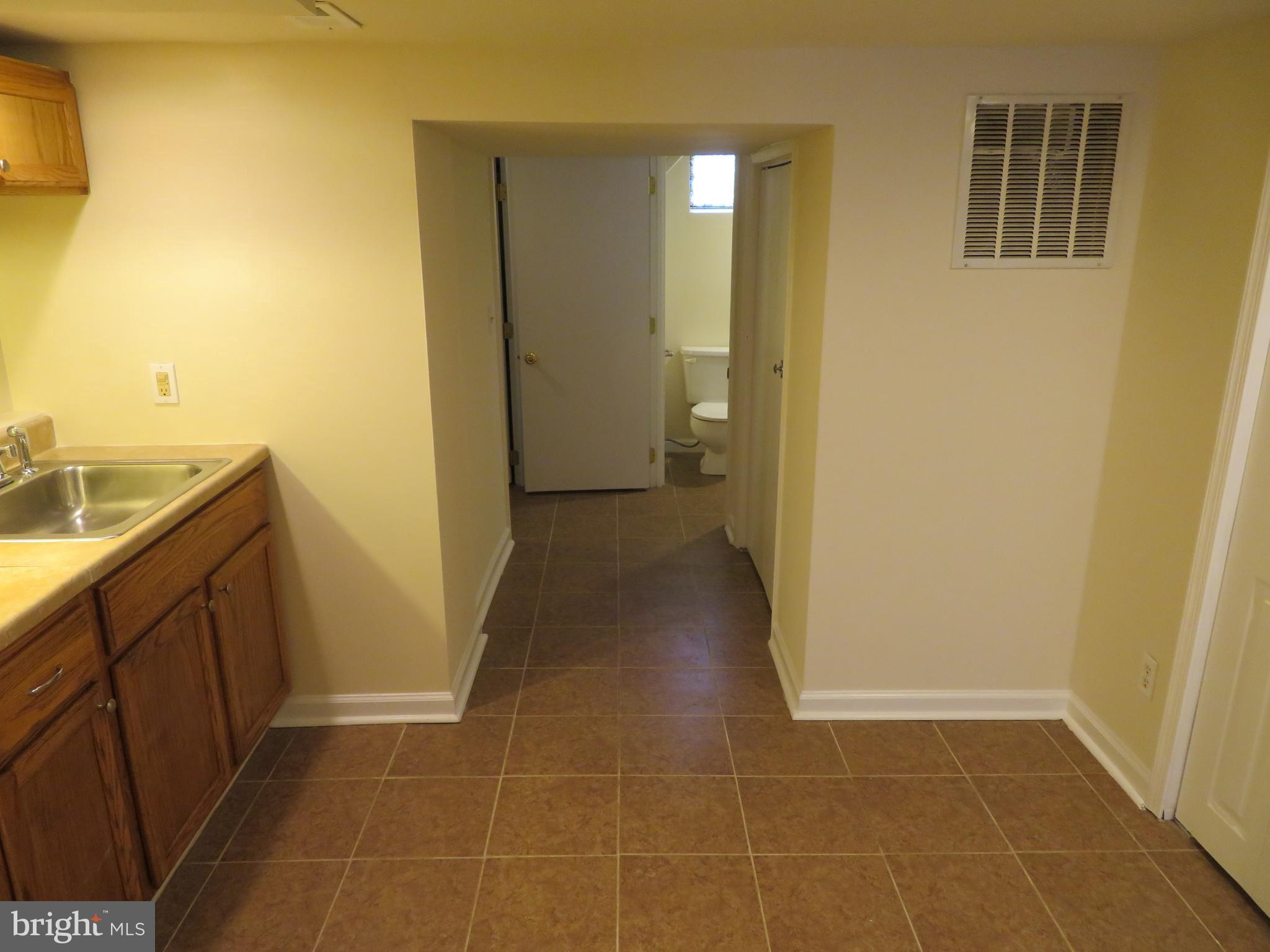 5414 Quesada Road Riverdale, MD 20737 - Photo 25 of 33 Basement Hallway to Bath and Laundry Rooms