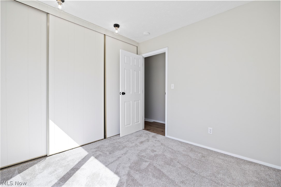 32969 Mills Road North Ridgeville, OH 44039 - Photo 23 of 29 Unfurnished bedroom with light carpet and a closet