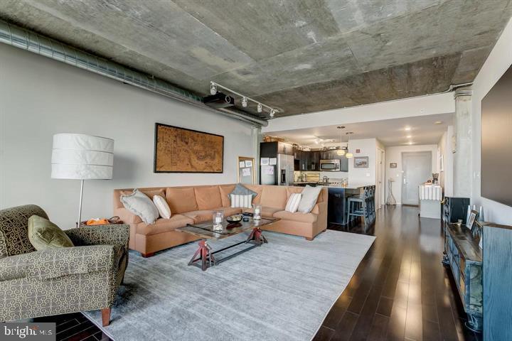 a living room with furniture and wooden floor