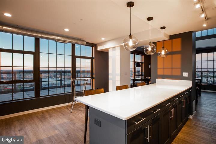 1200 Steuart Street, Unit 428 Baltimore, MD 21230 - Photo 13 of 53 a large kitchen with kitchen island a sink appliances and a large counter top space