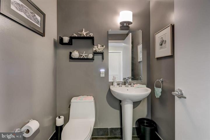 1200 Steuart Street, Unit 428 Baltimore, MD 21230 - Photo 14 of 53 a bathroom with a sink mirror and toilet