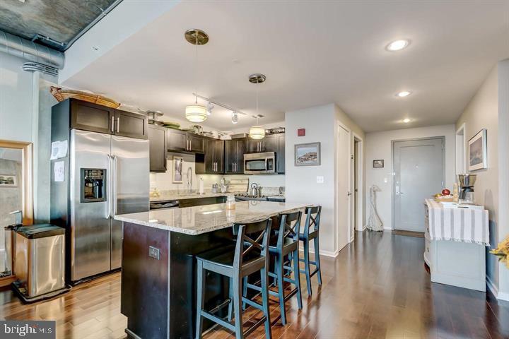 1200 Steuart Street, Unit 428 Baltimore, MD 21230 - Photo 16 of 53 a large kitchen with a table and chairs