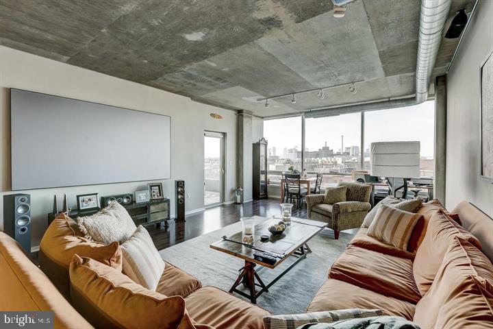 1200 Steuart Street, Unit 428 Baltimore, MD 21230 - Photo 24 of 53 a living room with furniture and floor to ceiling windows