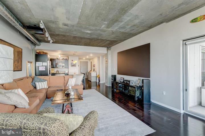 1200 Steuart Street, Unit 428 Baltimore, MD 21230 - Photo 26 of 53 a living room with furniture and a flat screen tv