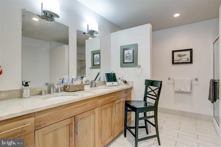 1200 Steuart Street, Unit 428 Baltimore, MD 21230 - Photo 33 of 53 a bathroom with a double vanity sink and a mirror
