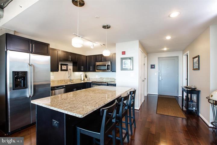 1200 Steuart Street, Unit 428 Baltimore, MD 21230 - Photo 4 of 53 a kitchen with cabinets and stainless steel appliances