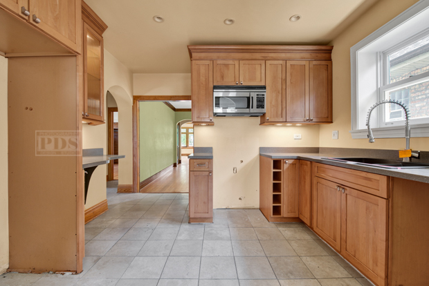 6727 Riverside Drive Berwyn, IL 60402 - Photo 11 of 30 a kitchen with stainless steel appliances granite countertop a refrigerator and microwave