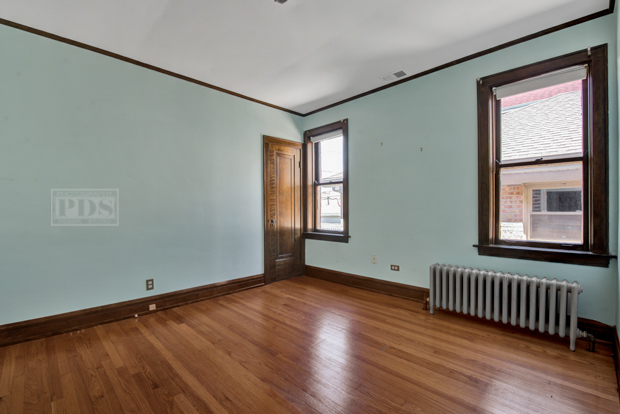 6727 Riverside Drive Berwyn, IL 60402 - Photo 16 of 30 an empty room with wooden floor and windows