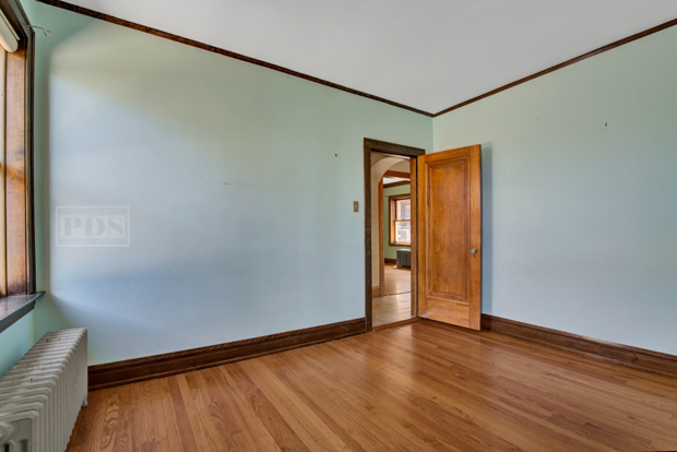 6727 Riverside Drive Berwyn, IL 60402 - Photo 17 of 30 a view of an empty room with wooden floor and a window