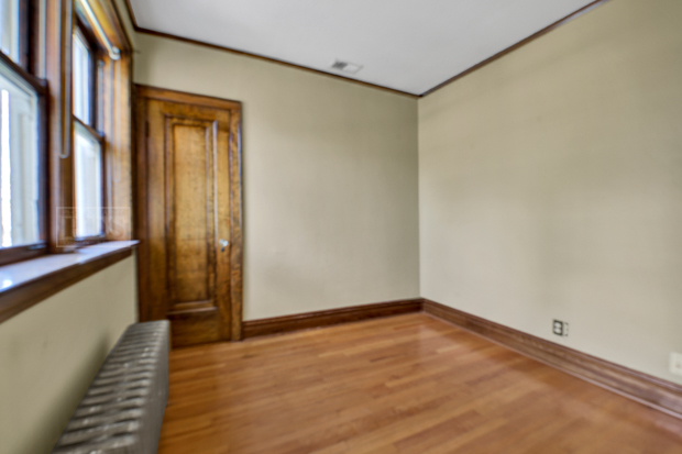 6727 Riverside Drive Berwyn, IL 60402 - Photo 20 of 30 a view of an empty room with wooden floor and a window