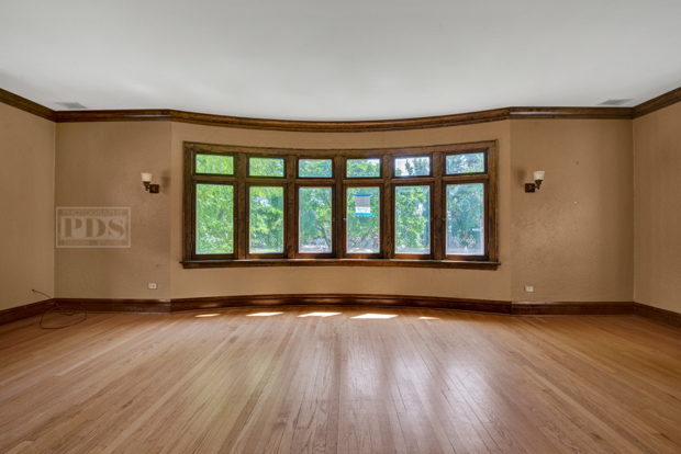6727 Riverside Drive Berwyn, IL 60402 - Photo 4 of 30 a view of an empty room with wooden floor and a window