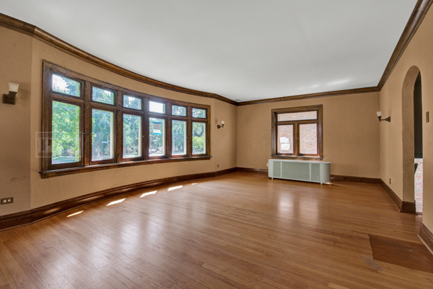 6727 Riverside Drive Berwyn, IL 60402 - Photo 5 of 30 a view of an empty room with window and wooden floor