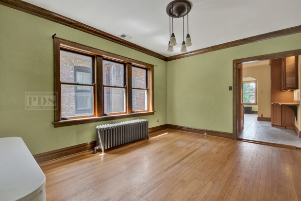 6727 Riverside Drive Berwyn, IL 60402 - Photo 6 of 30 a view of an empty room with window and wooden floor
