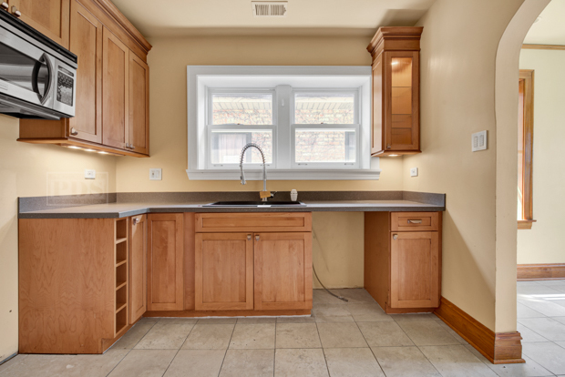 6727 Riverside Drive Berwyn, IL 60402 - Photo 9 of 30 a kitchen with stainless steel appliances granite countertop a sink and a granite counter tops