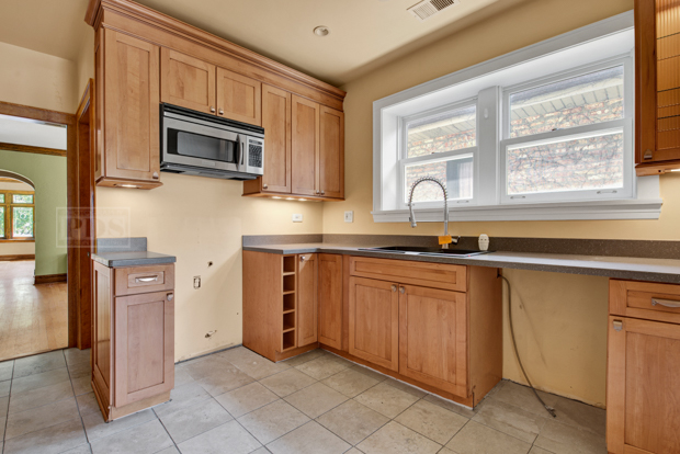 6727 Riverside Drive Berwyn, IL 60402 - Photo 10 of 30 a kitchen with stainless steel appliances granite countertop a refrigerator and a stove top oven
