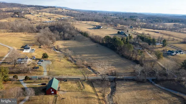 a view of a lake with lawn chairs