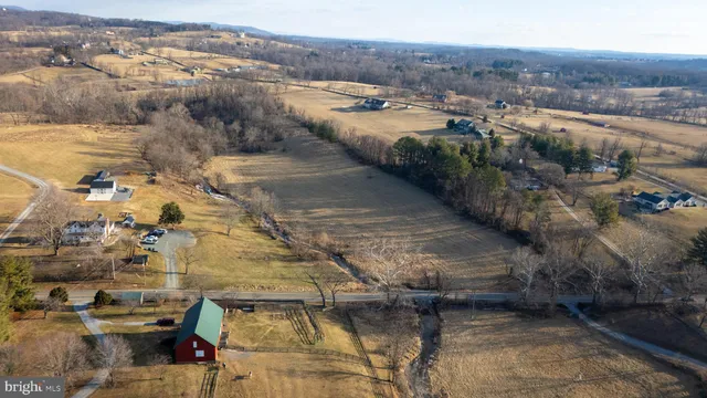 a view of a lake with lawn chairs