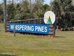 a view of a bench in a park next to a road