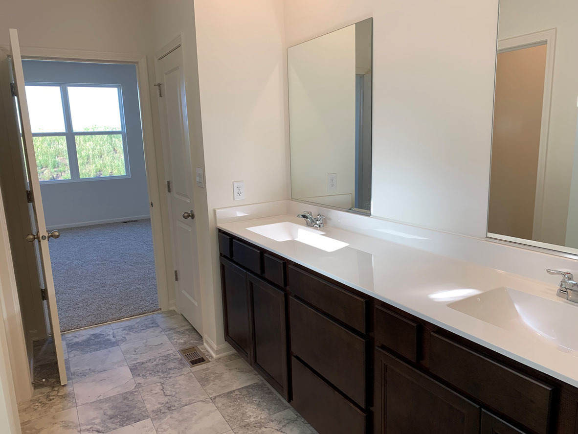 935 Eineke Boulevard Algonquin, IL 60102 - Photo 14 of 39 a bathroom with a double vanity sink a mirror and a bathtub