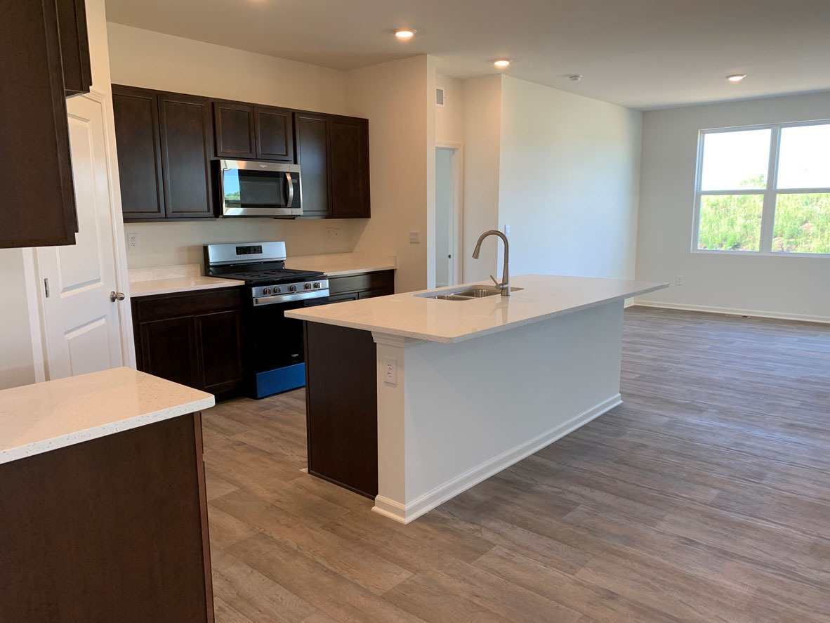 935 Eineke Boulevard Algonquin, IL 60102 - Photo 5 of 39 a kitchen with stainless steel appliances granite countertop a sink a stove top oven a refrigerator with wooden floors