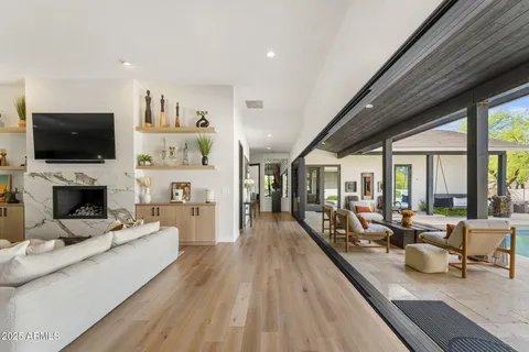a living room with furniture a flat screen tv and a fireplace