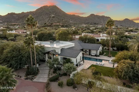 an aerial view of a house with yard
