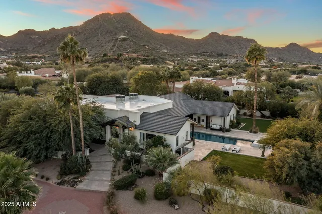 an aerial view of a house with yard