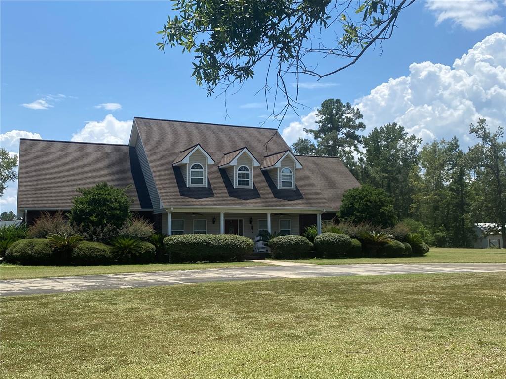 a front view of house with yard and green space