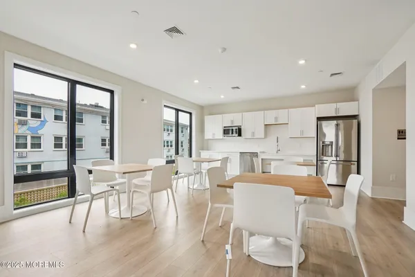 a dining room with furniture and wooden floor