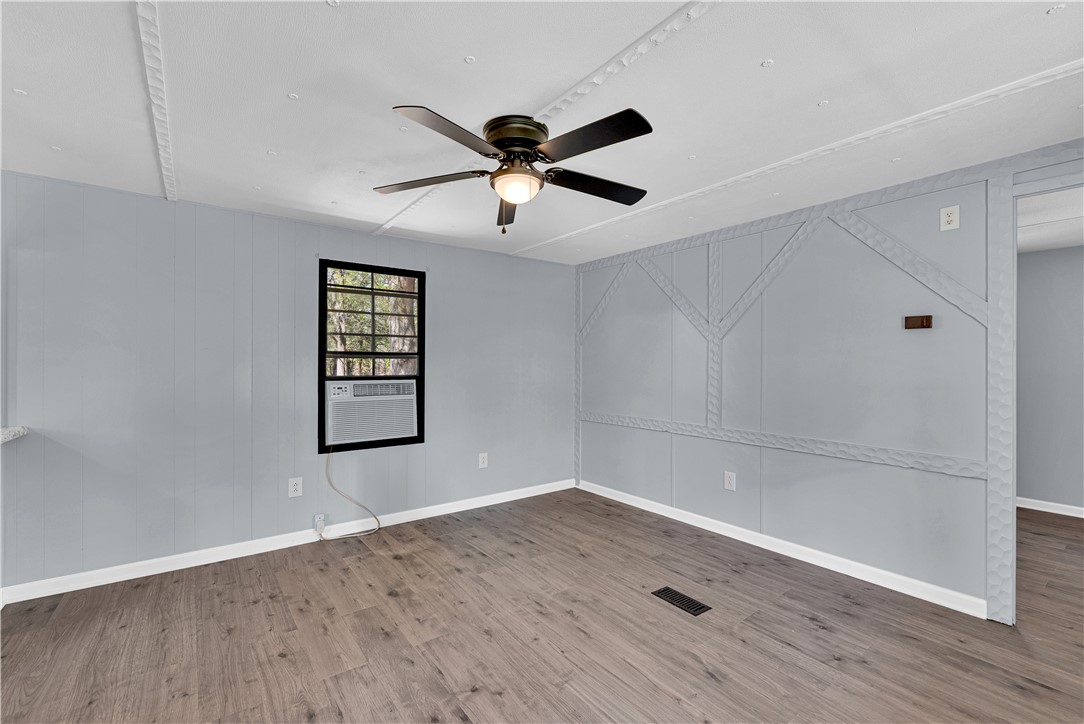 This bright room features a window with a view of lush greenery, offering a serene atmosphere.