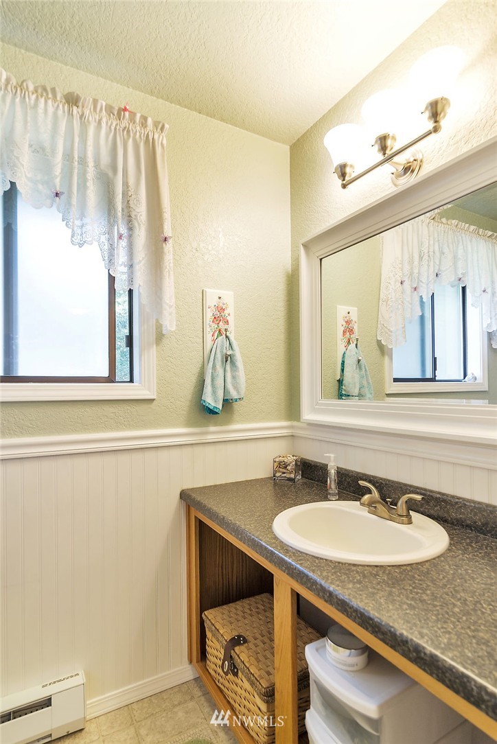 24517 Florence Acres Road Monroe, WA 98272 - Photo 7 of 14 a bathroom with a granite countertop sink and a mirror