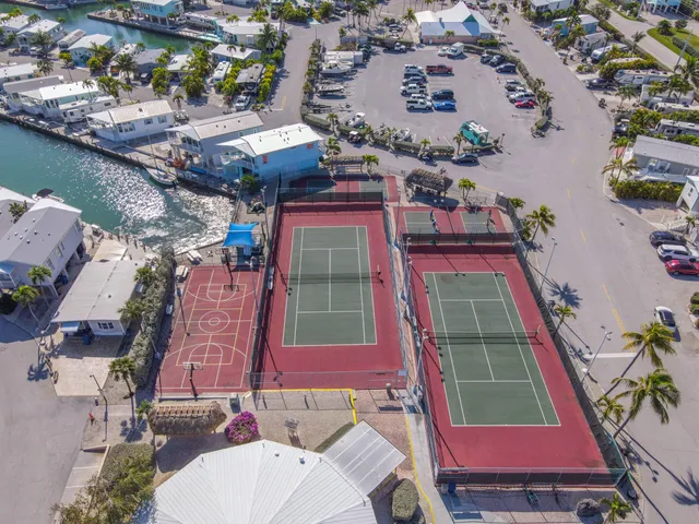 an aerial view of a house with garden space and a patio