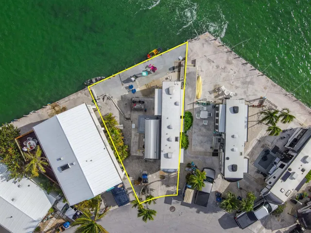 an aerial view of multiple houses with yard