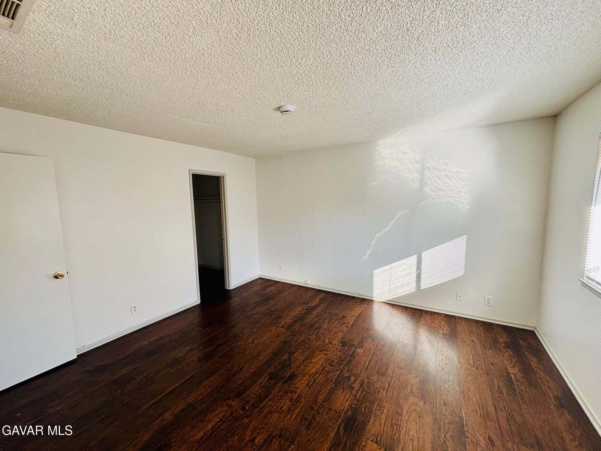 2308 Edam Street Lancaster, CA 93536 - Photo 13 of 16 a view of an empty room with wooden floor