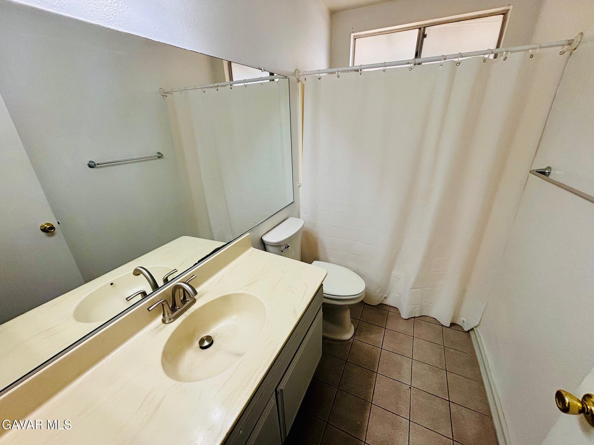 2308 Edam Street Lancaster, CA 93536 - Photo 14 of 16 a bathroom with a sink and a mirror